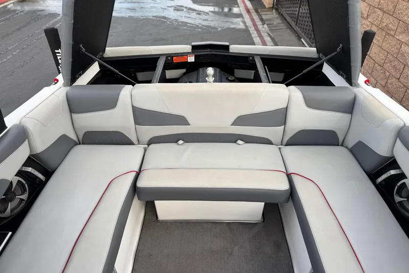 Slide: The Image of 2020 Malibu Wakesetter 22 LSV interior with gray and white seating, red accents. - 23