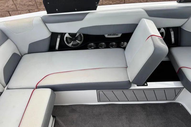 Slide: The Image of 2020 Malibu Wakesetter 22 LSV interior seating with gray upholstery and red accents. - 28