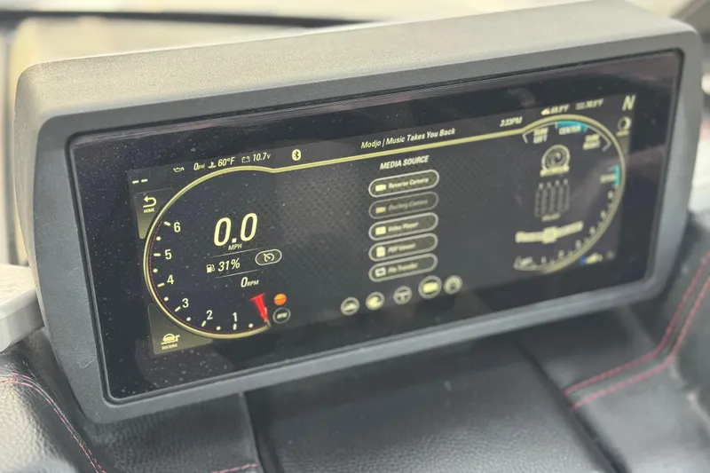 Slide: The Image of Dashboard display of a 2020 Malibu Wakesetter 22 LSV boat, showing speed and media controls. - 40