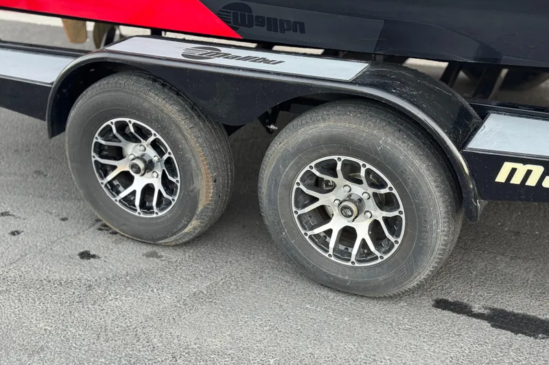 Slide: The Image of Trailer wheels of a 2020 Malibu Wakesetter 22 LSV on pavement. - 44