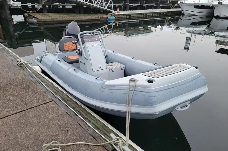 The Image of 2023 Highfield Sport 360 boat docked at marina, featuring sleek design and modern seating. - 0