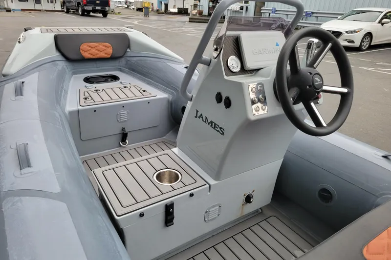 Slide: The Image of 2023 Highfield Sport 360 boat interior with steering console and seating. - 12