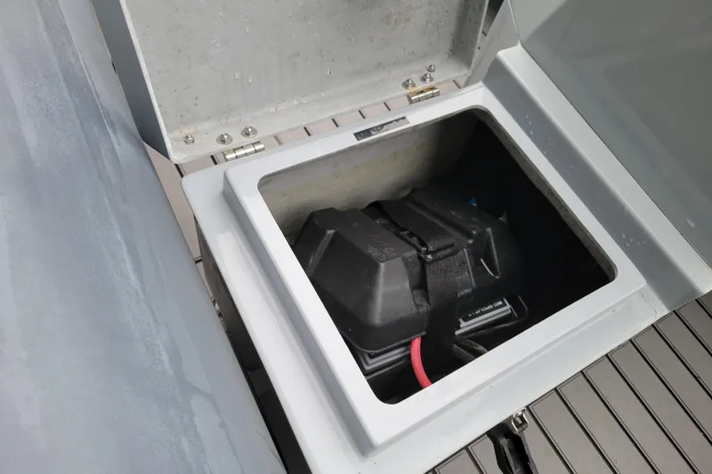 Slide: The Image of Open storage compartment in 2023 Highfield Sport 360 boat, showing secured battery. - 13