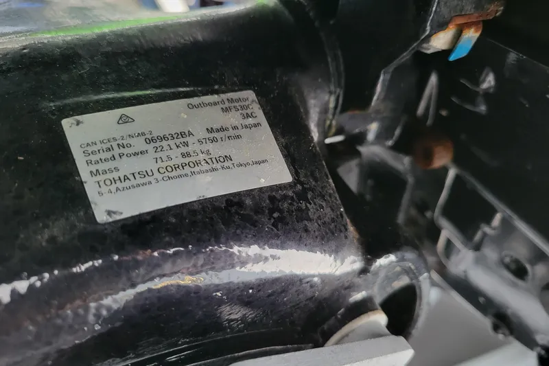 Slide: The Image of Label on Tohatsu outboard motor, model MFS30C, showing specifications and serial number. - 19
