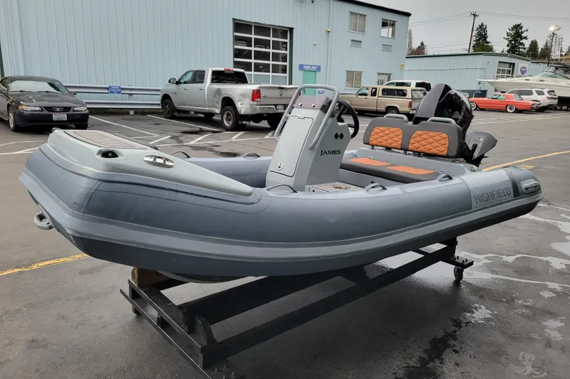 Slide: The Image of 2023 Highfield Sport 360 inflatable boat in a parking lot, showcasing sleek design and modern features. - 3