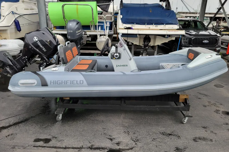 Slide: The Image of 2023 Highfield Sport 360 inflatable boat with Tohatsu and Yamaha engines, docked at marina. - 5