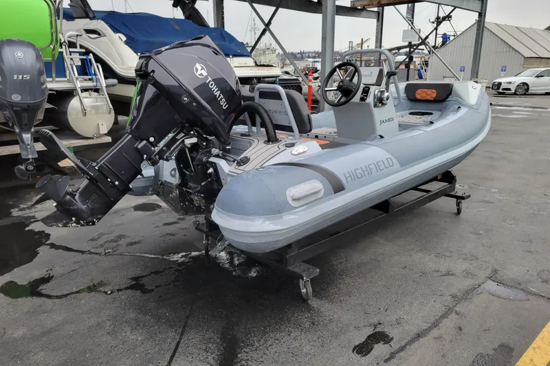 Slide: The Image of 2023 Highfield Sport 360 boat with Tohatsu engine on a trailer in a marina. - 6