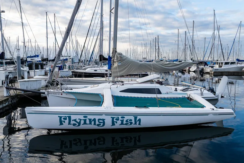 The Image of 2001 Corsair F-28 CC sailboat "Flying Fish" docked in a marina, surrounded by other boats. - 0