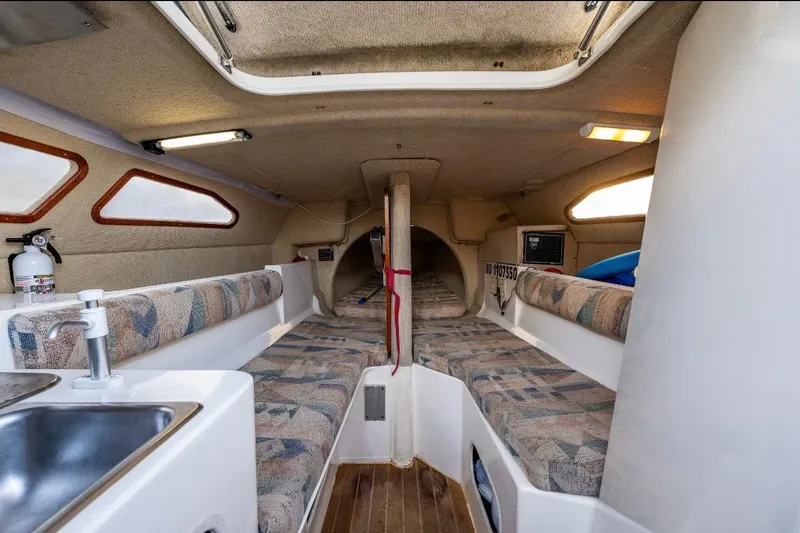 Slide: The Image of Interior of 2001 Corsair F-28 CC sailboat with seating, sink, and cozy cabin layout. - 11