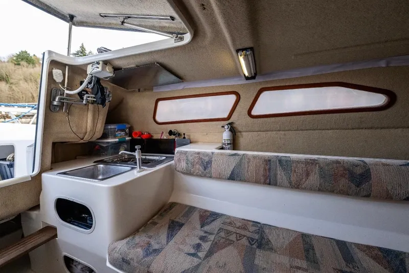 Slide: The Image of Interior of 2001 Corsair F-28 CC sailboat with kitchenette and seating area. - 13