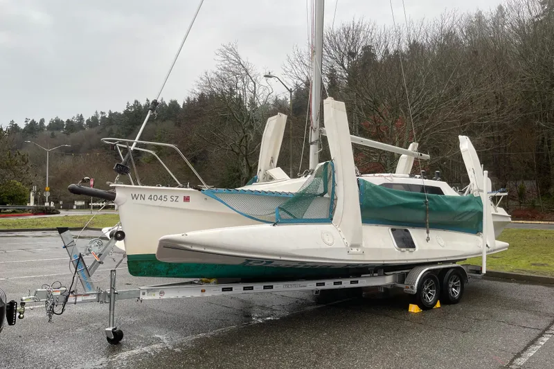 Slide: The Image of Corsair F-28 CC 2001 sailboat on trailer, parked in a scenic outdoor setting. - 4