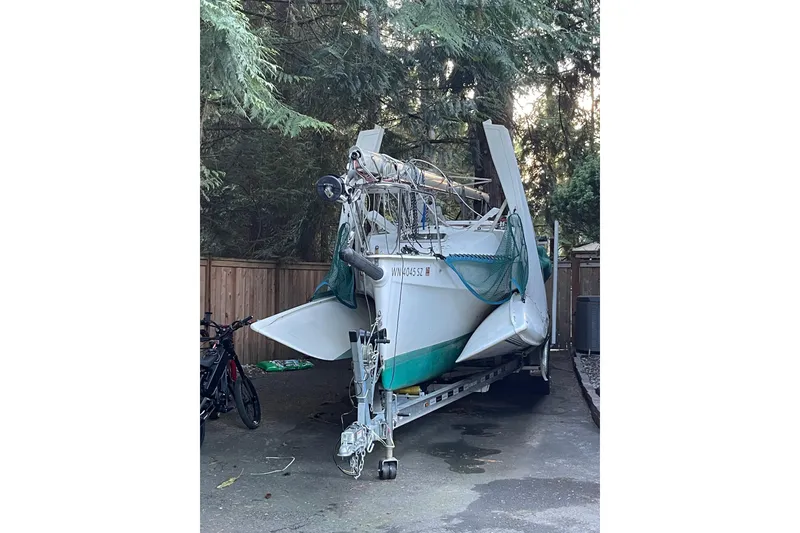 Slide: The Image of 2001 Corsair F-28 CC sailboat on trailer, parked in wooded area. - 5