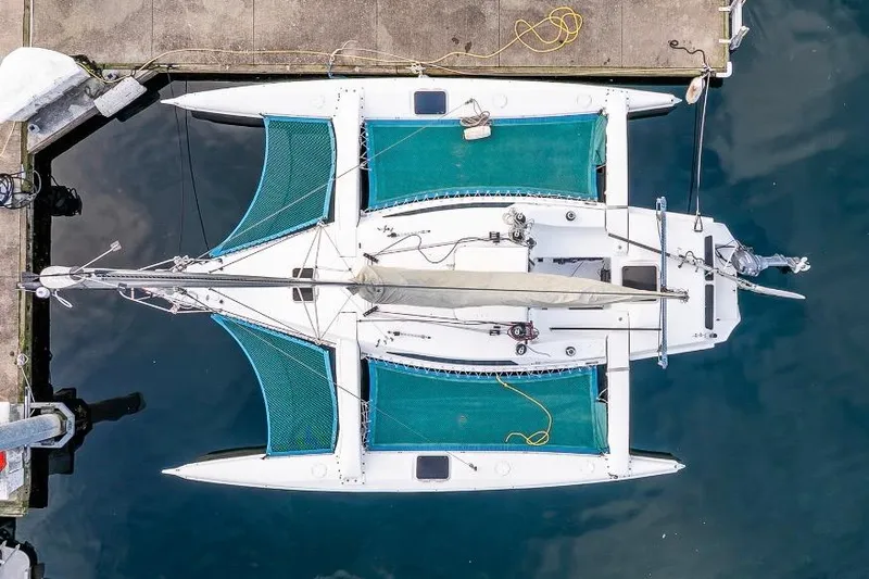 Slide: The Image of Overhead view of a 2001 Corsair F-28 CC trimaran docked at a marina. - 6