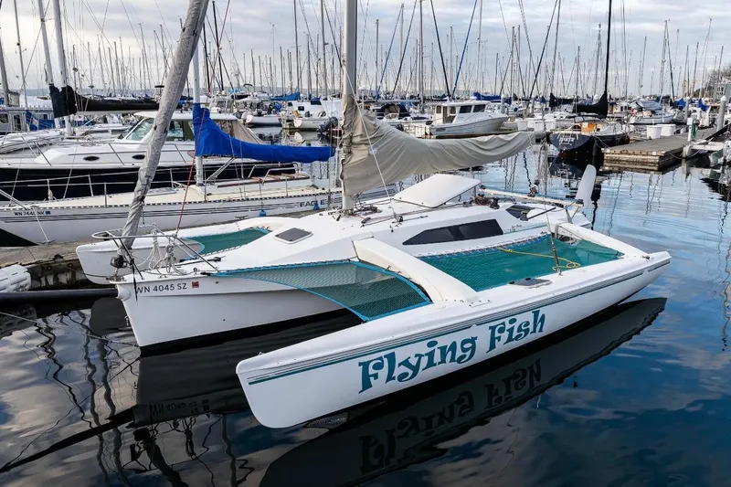Slide: The Image of Sailboat "Flying Fish" docked, Corsair F-28 CC, 2001 model, marina background. - 8