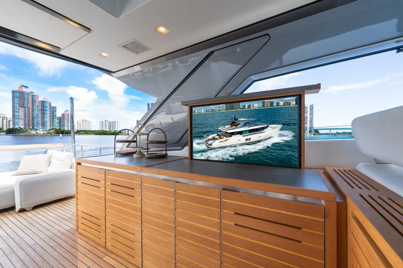 Slide: The Image of Luxurious 2021 Sanlorenzo SX76 yacht interior with wooden cabinetry and waterfront view. - 15