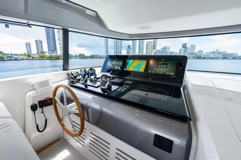 Slide: The Image of Helm of 2021 Sanlorenzo SX76 yacht with modern navigation equipment and city skyline view. - 17