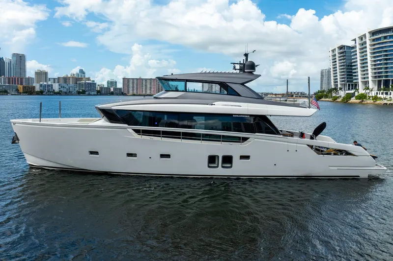 Slide: The Image of Luxury 2021 Sanlorenzo SX76 yacht cruising near city skyline. - 2