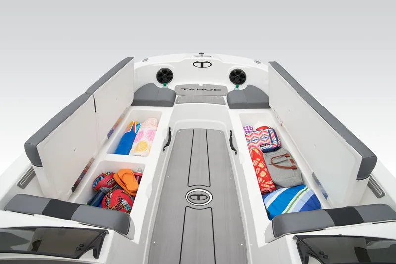 Slide: The Image of Manufacturer Provided Image: 2025 Tahoe T21 boat interior with open storage compartments, showcasing colorful towels and bags. - 10