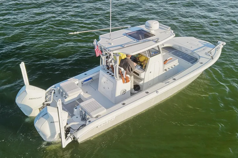 Slide: The Image of 2024 Costa Custom Boats 264 HC on water, featuring dual Mercury engines. - 10
