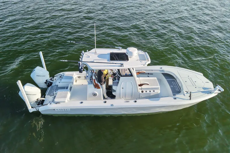 Slide: The Image of 2024 Costa Custom Boats 264 HC on water, showcasing sleek design and dual Mercury engines. - 11