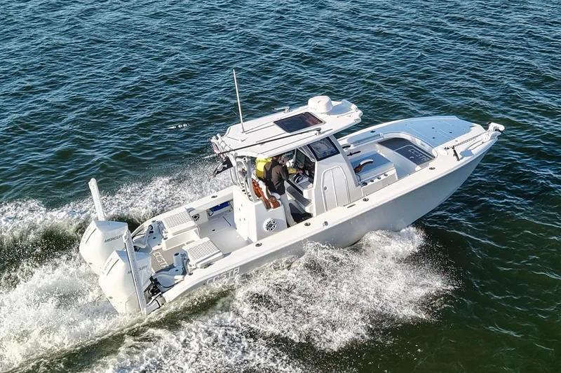 Slide: The Image of 2024 Costa Custom Boats 264 HC cruising on open water. - 15