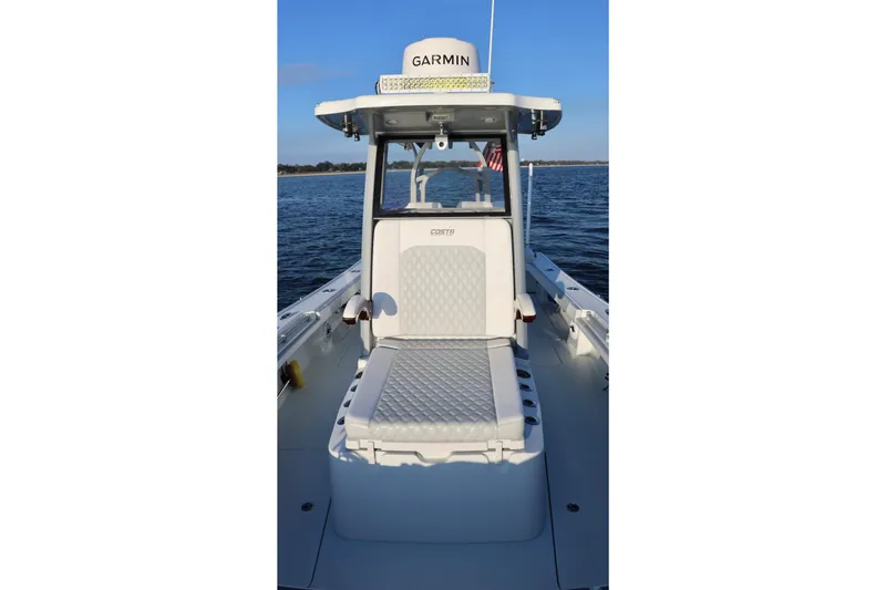 Slide: The Image of 2024 Costa Custom Boats 264 HC on water, featuring Garmin equipment and comfortable seating. - 18
