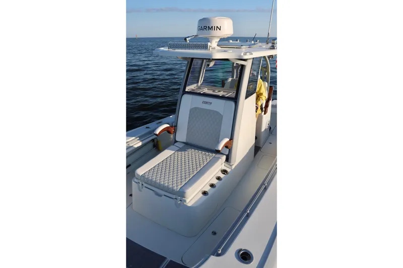Slide: The Image of 2024 Costa Custom Boats 264 HC on water, featuring Garmin equipment and cushioned seating. - 19