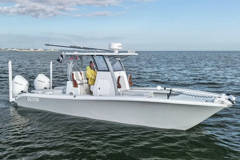 Slide: The Image of 2024 Costa Custom Boats 264 HC on open water, featuring dual Mercury engines. - 2
