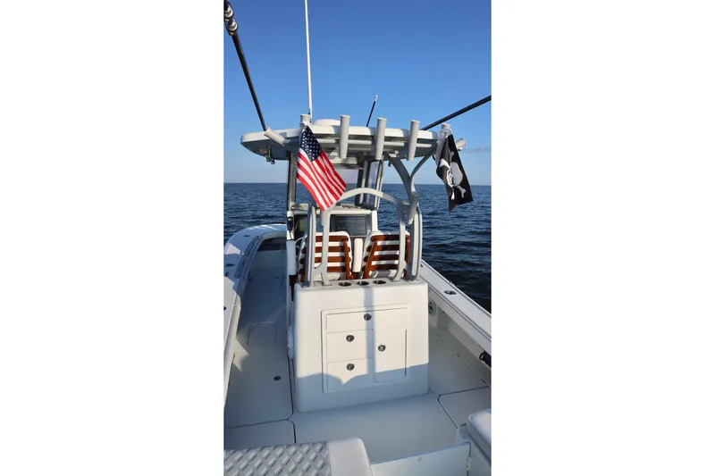 Slide: The Image of 2024 Costa Custom Boats 264 HC on open water, featuring American and pirate flags. - 20