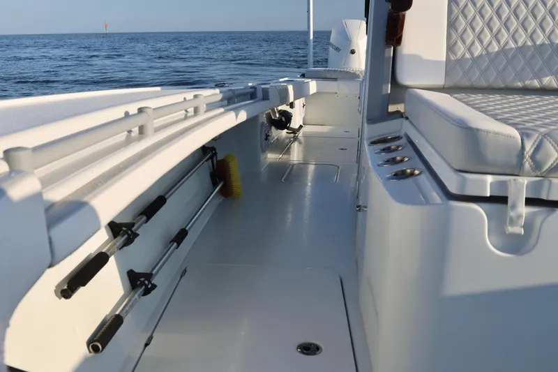 Slide: The Image of 2024 Costa Custom Boats 264 HC interior with rod holders and cushioned seating. - 27