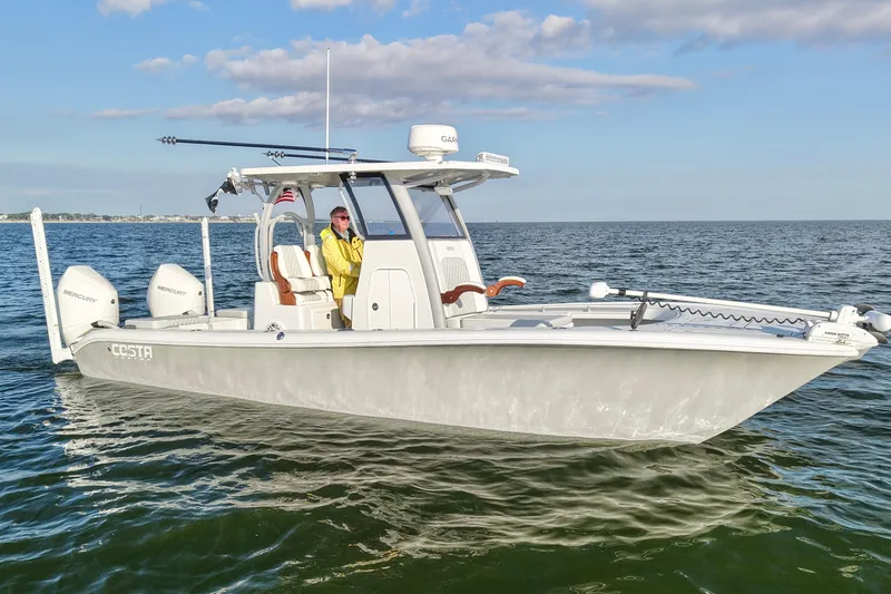 Slide: The Image of 2024 Costa Custom Boats 264 HC cruising on open water under a clear sky. - 3