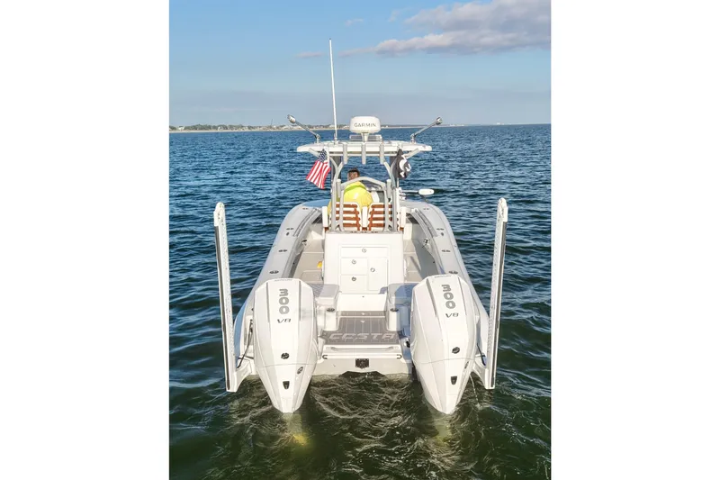 Slide: The Image of 2024 Costa Custom Boats 264 HC on water, rear view with dual engines. - 7