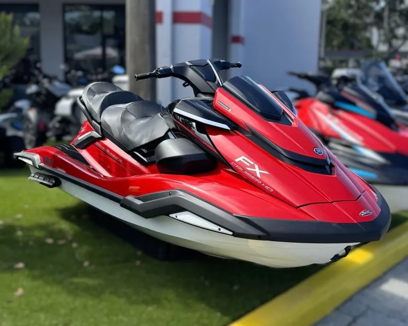 The Image of A red 2026 Yamaha WaveRunner FX Cruiser® HO is displayed on grass. It features three seats. - 0