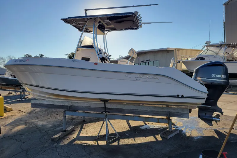 Slide: The Image of 2008 Cobia 235 Center Console boat on stand, Yamaha outboard, sunny day. - 2