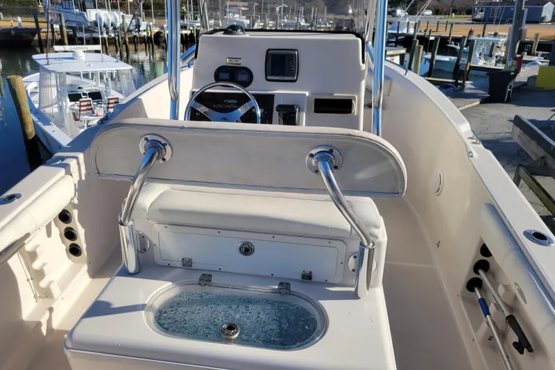 Slide: The Image of 2008 Cobia 235 Center Console boat interior with steering wheel and seating area. - 6