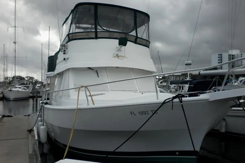 The Image of 1997 Mainship 350 docked at marina under cloudy skies. - 0