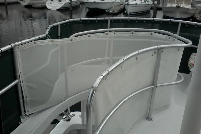 Slide: The Image of 1997 Mainship 350 yacht deck with railing and canvas enclosure at marina. - 11