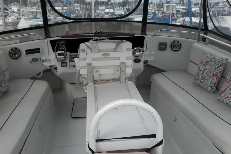 Slide: The Image of 1997 Mainship 350 boat interior with helm, seating, and nautical decor. - 13