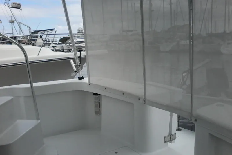 Slide: The Image of 1997 Mainship 350 boat interior with marina view through transparent curtains. - 15