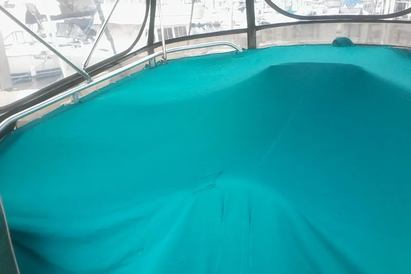 Slide: The Image of 1997 Mainship 350 boat interior with teal cover and metal frame. - 19