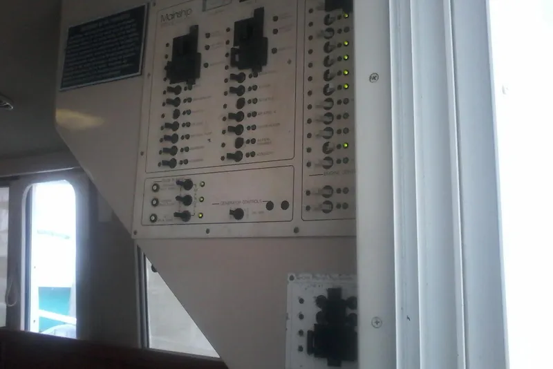 Slide: The Image of Control panel inside a 1997 Mainship 350 boat, featuring switches and indicators. - 25