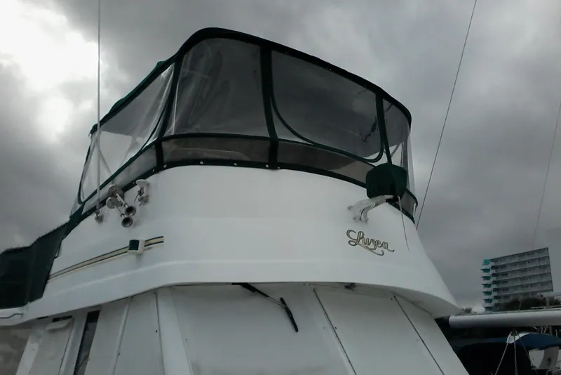 Slide: The Image of 1997 Mainship 350 boat with enclosed flybridge under cloudy sky. - 3