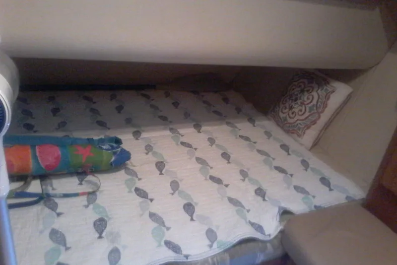 Slide: The Image of Cozy cabin bed in 1997 Mainship 350 with patterned bedding and decorative pillow. - 33