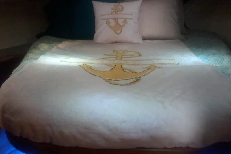 Slide: The Image of Cozy bed in 1997 Mainship 350 yacht with anchor-themed bedding and pillows. - 34