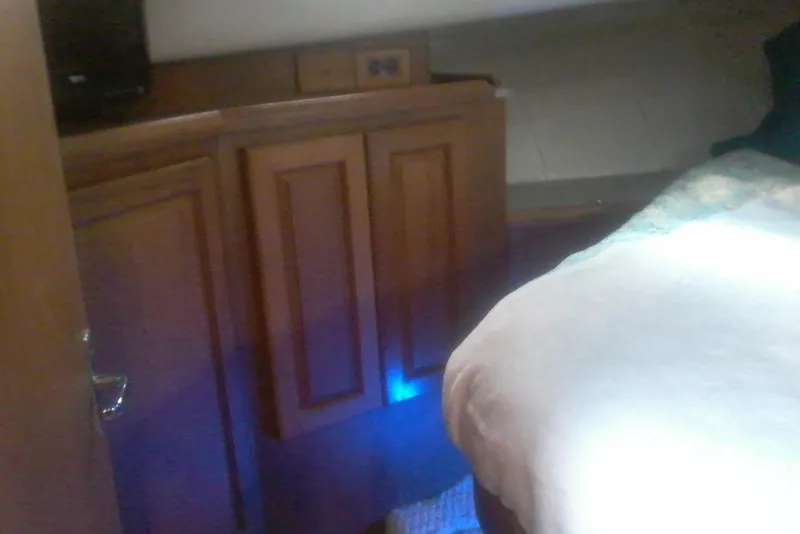 Slide: The Image of Interior cabin of 1997 Mainship 350 with wooden cabinetry and bed. - 35