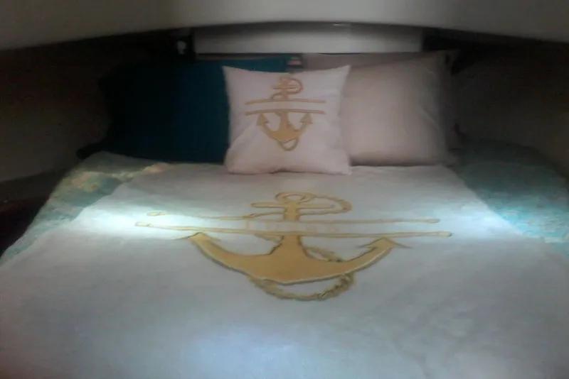 Slide: The Image of Cozy cabin bed in 1997 Mainship 350 with anchor-themed bedding. - 36