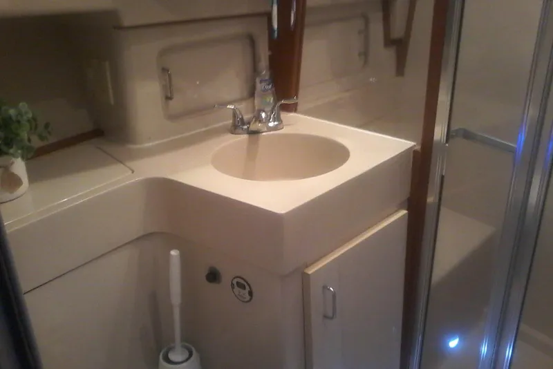 Slide: The Image of Bathroom interior of a 1997 Mainship 350 yacht with sink and shower. - 37