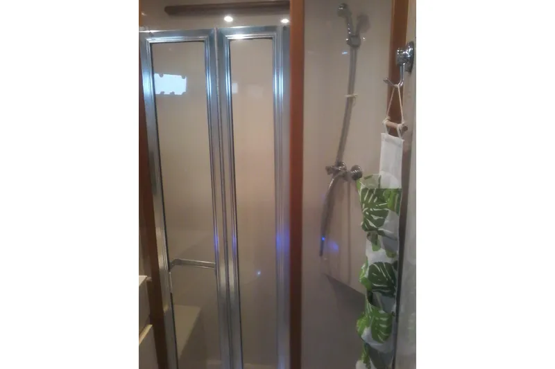 Slide: The Image of Shower area in 1997 Mainship 350 yacht with glass doors and tropical decor. - 38