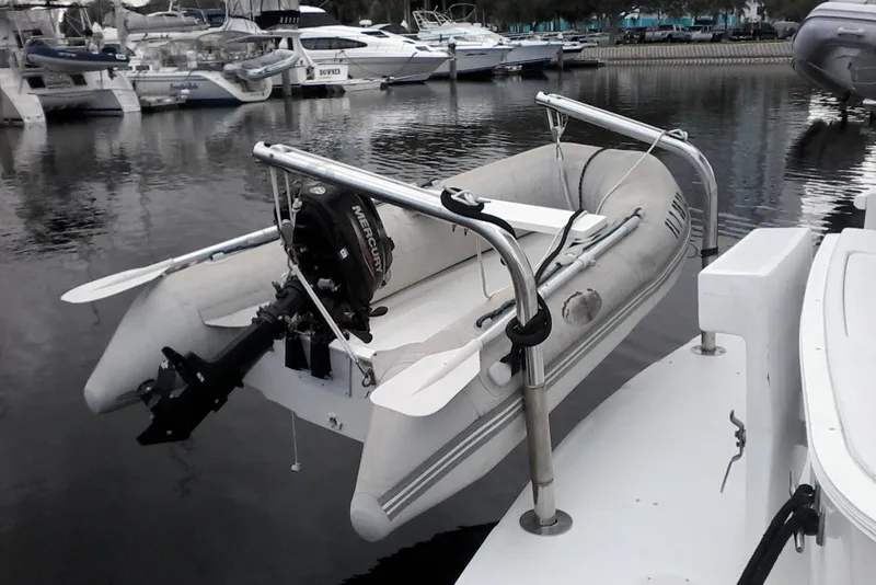 Slide: The Image of Inflatable boat with Mercury motor on 1997 Mainship 350 yacht in marina. - 4