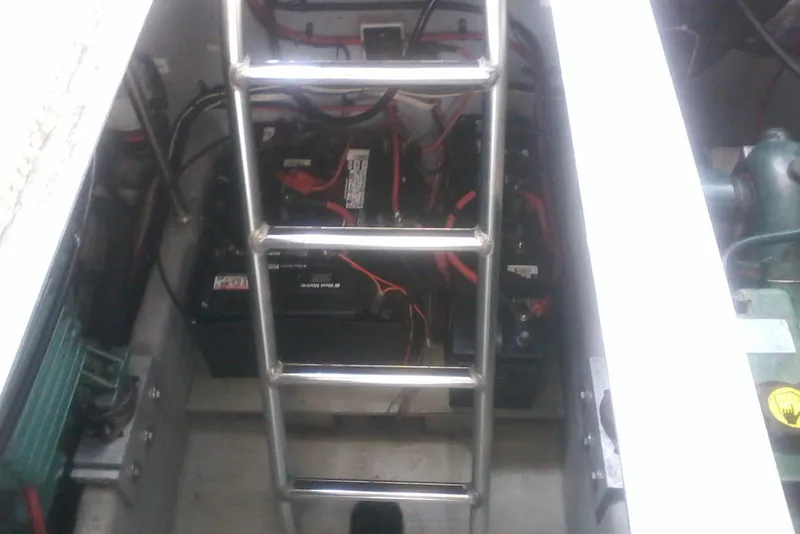 Slide: The Image of Engine compartment of 1997 Mainship 350 with batteries and wiring visible. - 41